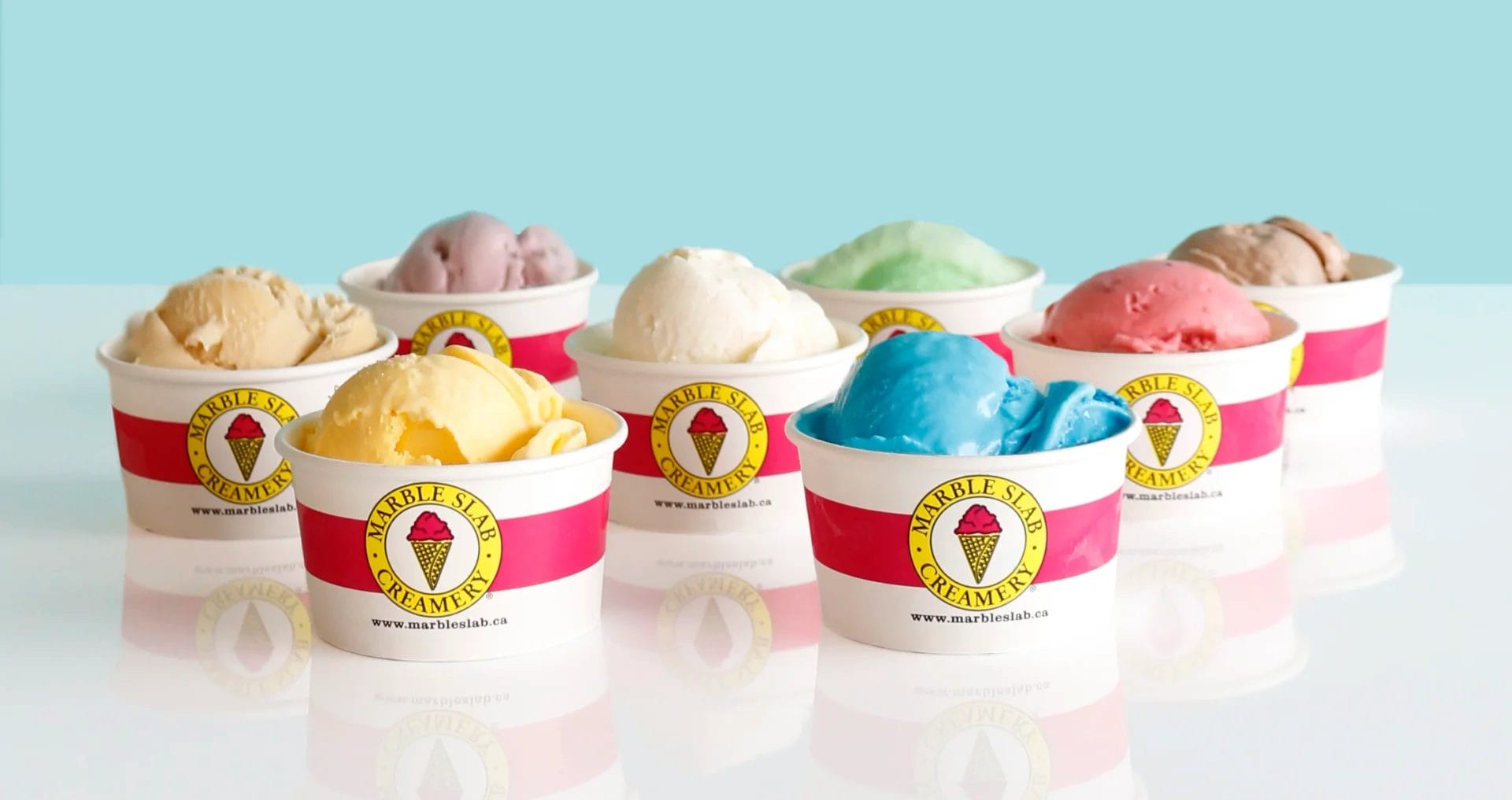 Half a dozen single scoops of ice cream in cups