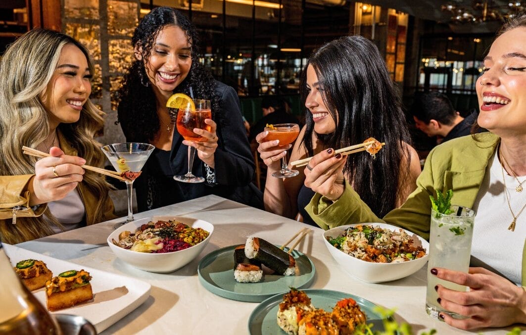 Group of friends enjoying a meal at a food market.