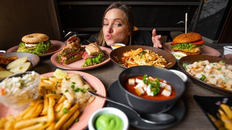 Woman with different types of food on the table