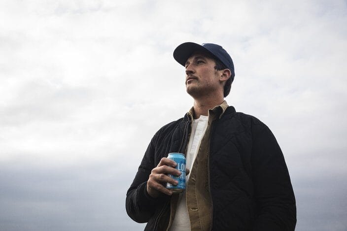 Miles Teller holding a can of Finnish Long Drink