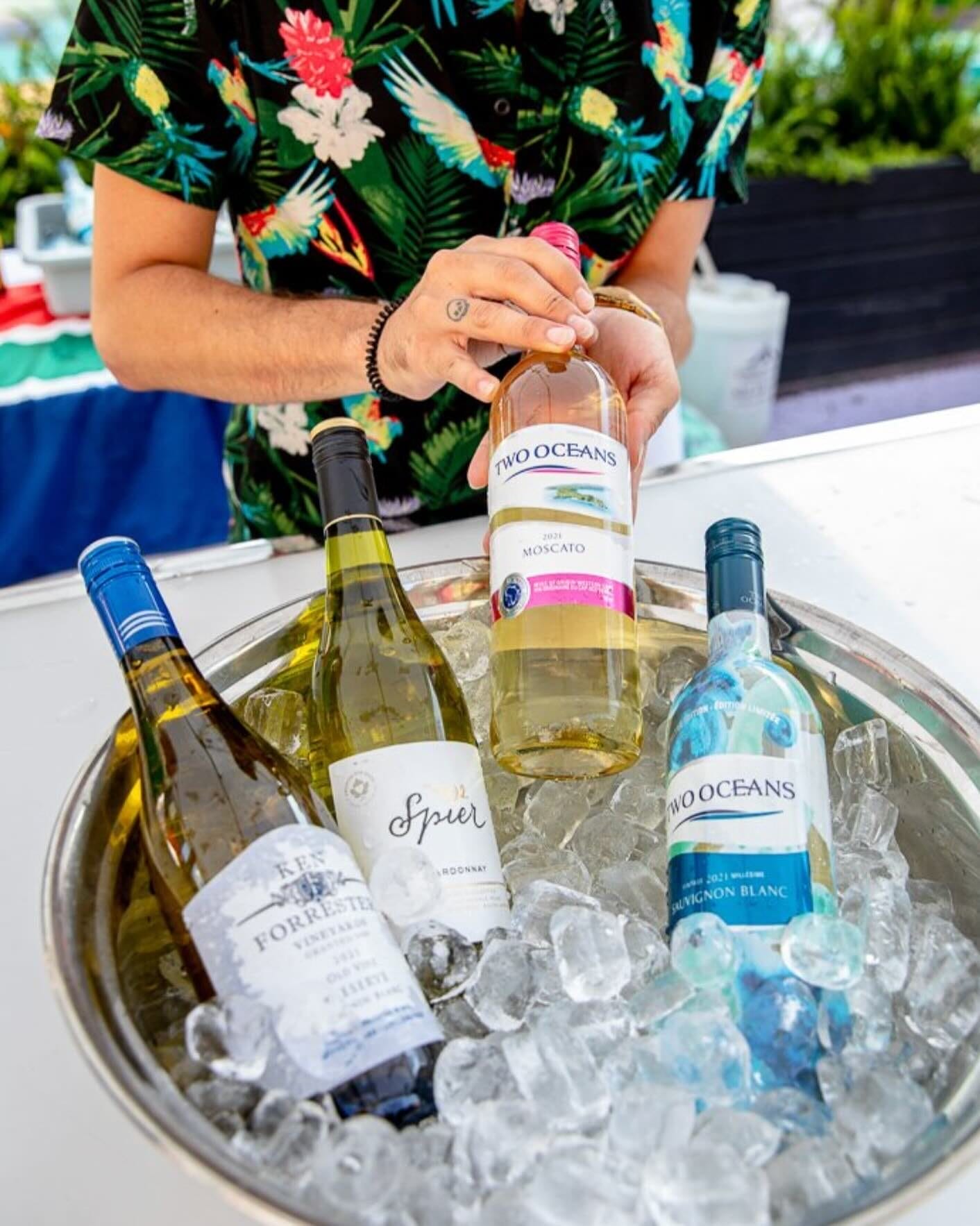 A person holding a bottle of Two Oceans Moscato above an ice-filled bowl with chilled white wines from South African wineries at Wine Fest Toronto. Photo from @winefesttoronto on Instagram, featured in the First-Timers Guide to Wine Fest Toronto 2025.