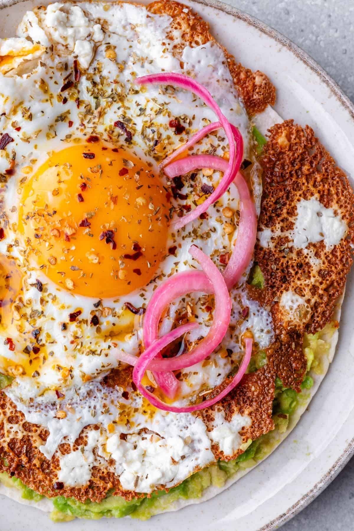 Crispy Feta Fried Egg with ickled onion, smashed avocado, and chili flakes