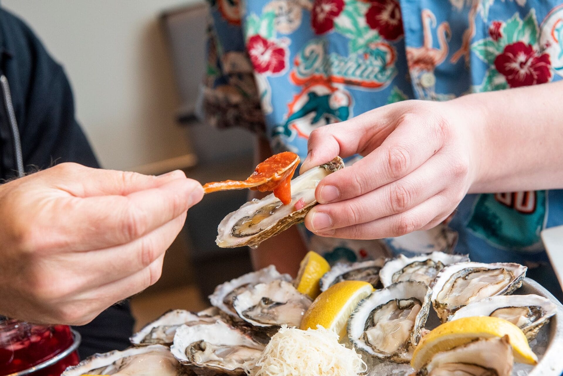 huge plate of oysters being enjoyed