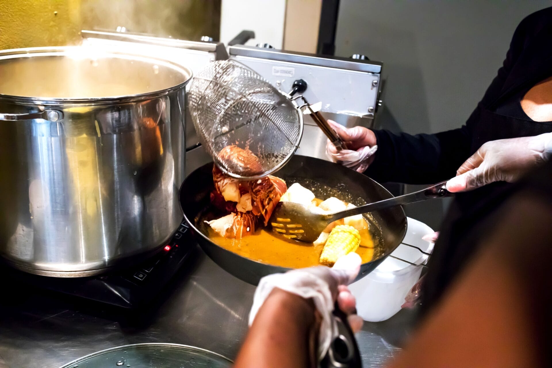 the behind the scene of the restaurant, seafood being boiled and  plated
