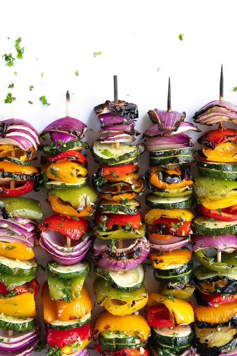 Chopped up onion, peppers and zucchini put through wooden skewers.
