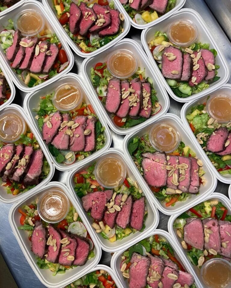 Meal kits with steak and vegetables in containers