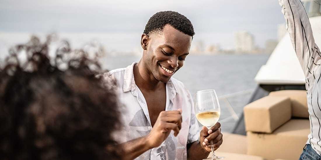 man sipping wine on a cruise