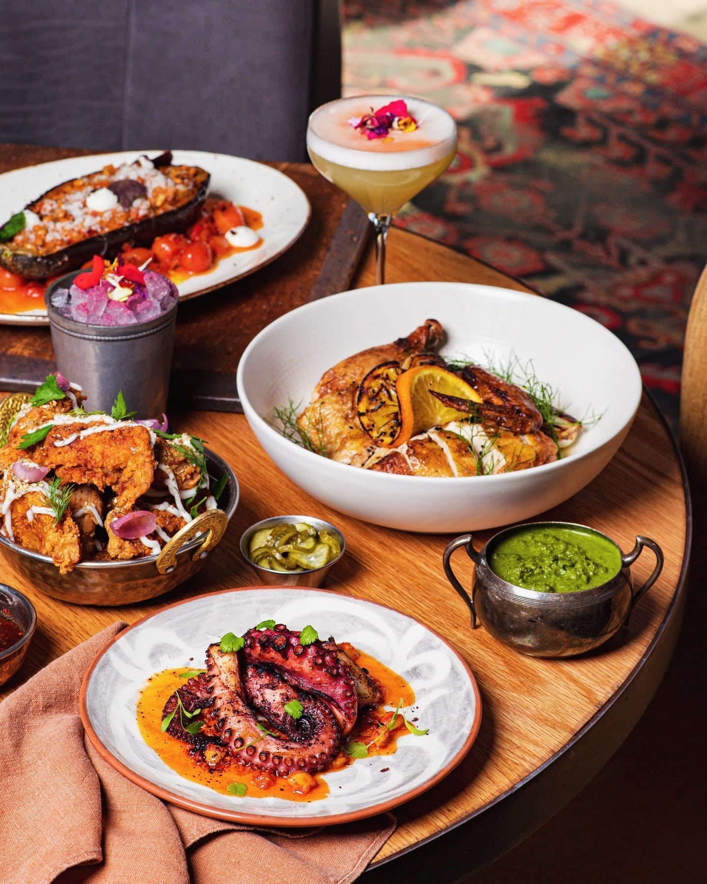 A table set with numerous plates of food, displaying an array of culinary delights prepared for guests, perfect for Summerlicious 2025 dining in Toronto