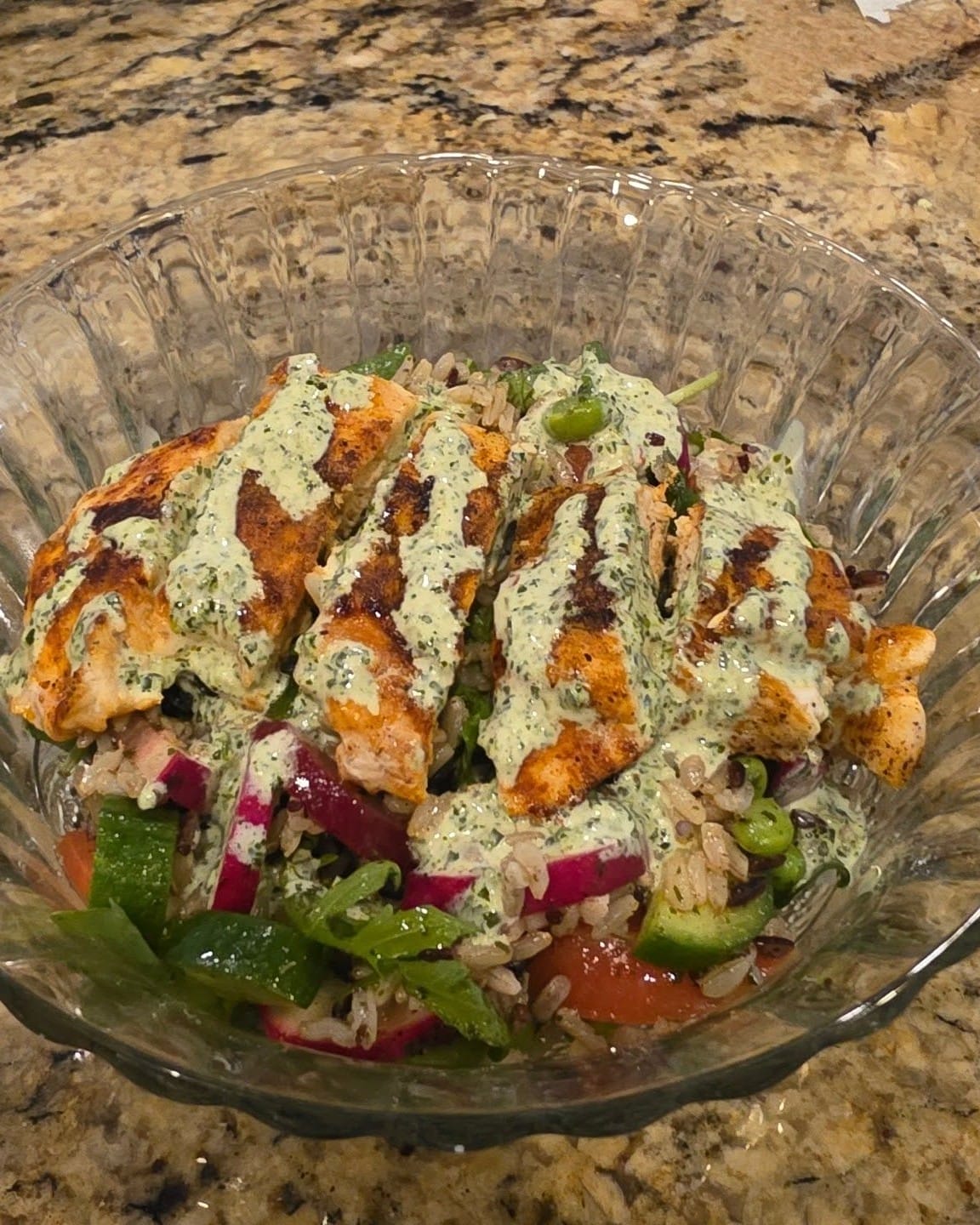 Chimichurri chicken grain bowl with grilled chicken, rice, fresh veggies, and creamy sauce for a healthy Father’s Day dinner