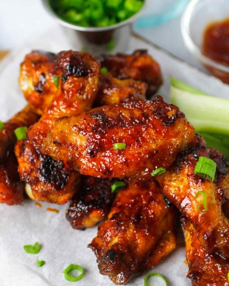 Sticky Bourbon Glazed Chicken Wings – a Father’s Day BBQ treat with a sweet, smoky bourbon sauce, garnished with fresh green onions for a vibrant finish.