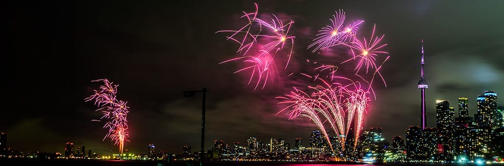 Fireworks over Toronto skyline at night