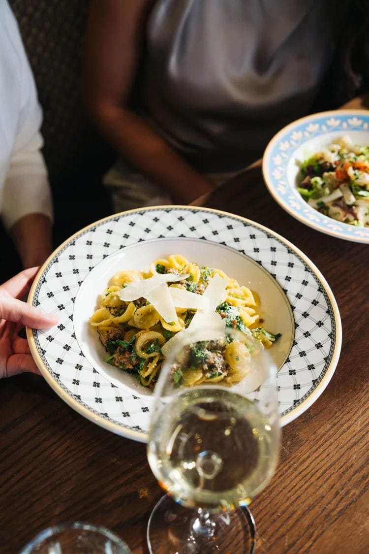 Handmade pasta and wine at Enoteca Rossio, a stylish Italian restaurant in Toronto with a hidden speakeasy.