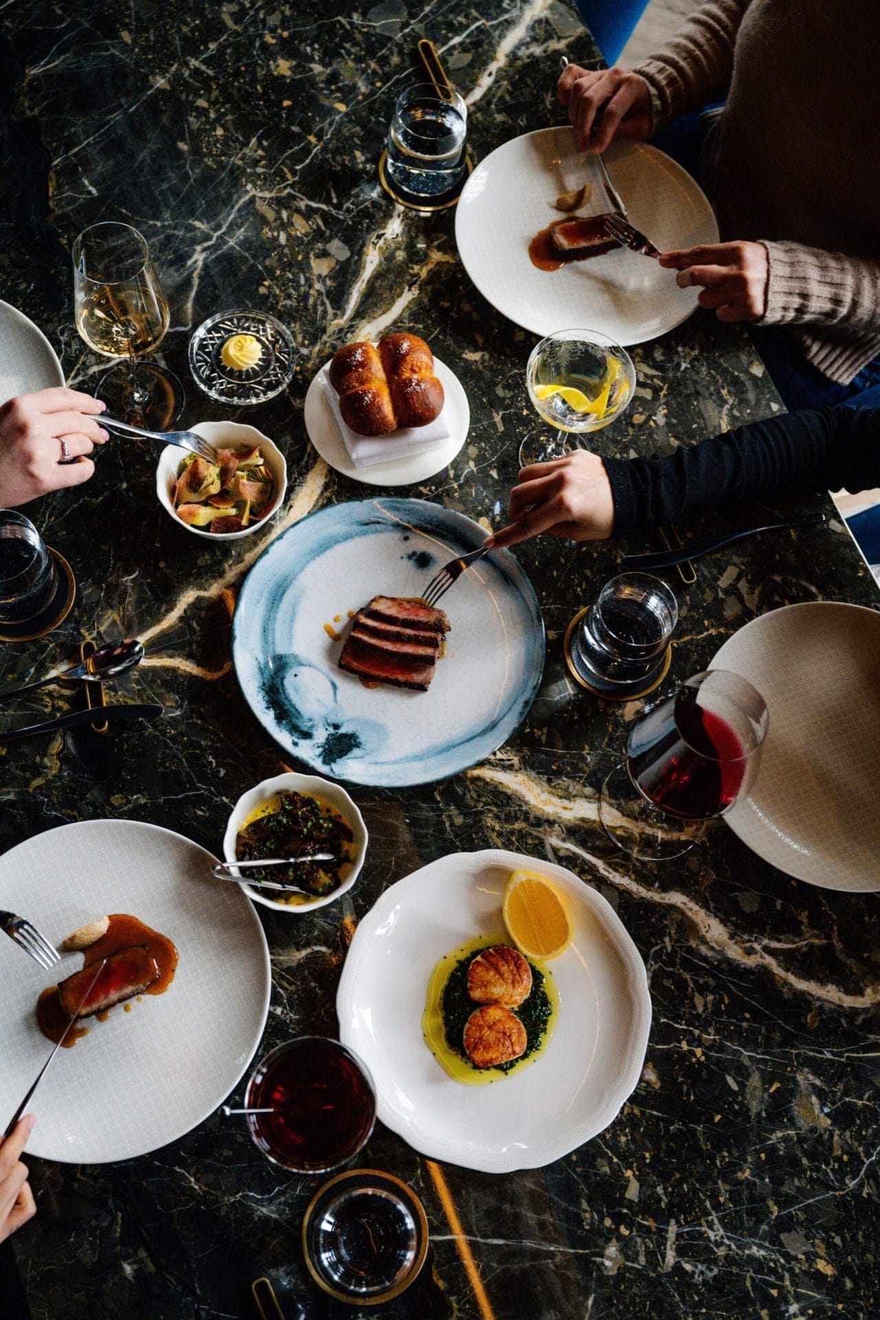 Guests enjoying a refined tasting menu experience at Alo.