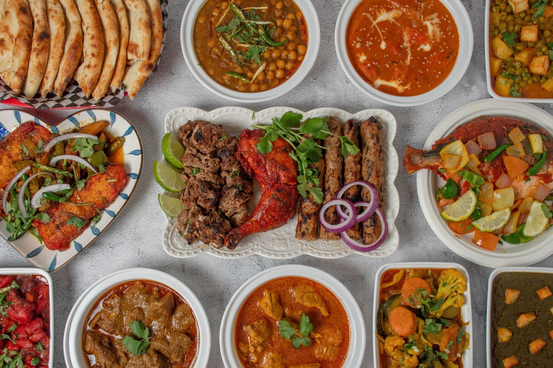 Curries, naan, and grilled meats from Makkah Restaurant, one of the best affordable restaurants in Toronto