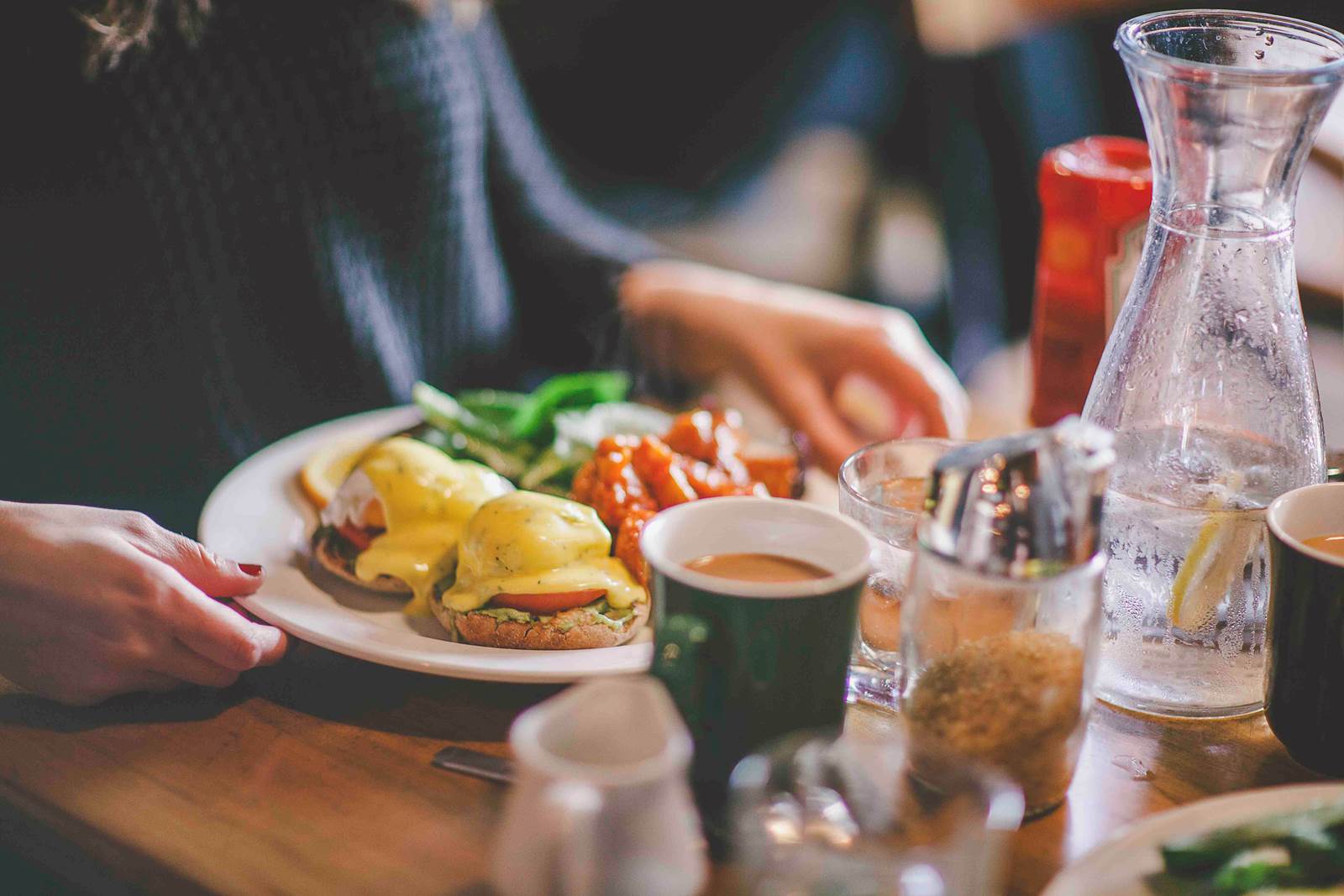 Eggs benedict and coffee during brunch service at Insomnia Restaurant in Toronto