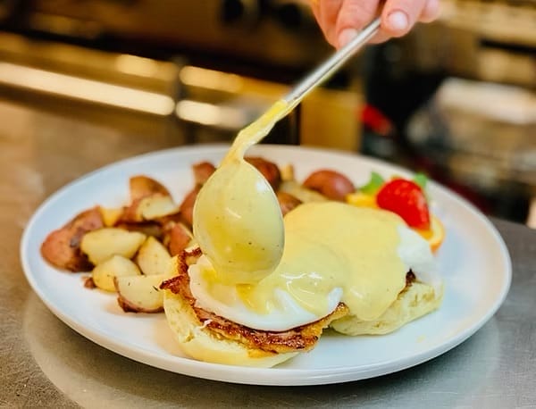 Breakfast plate with eggs benedict and home fries at Emma’s Country Kitchen