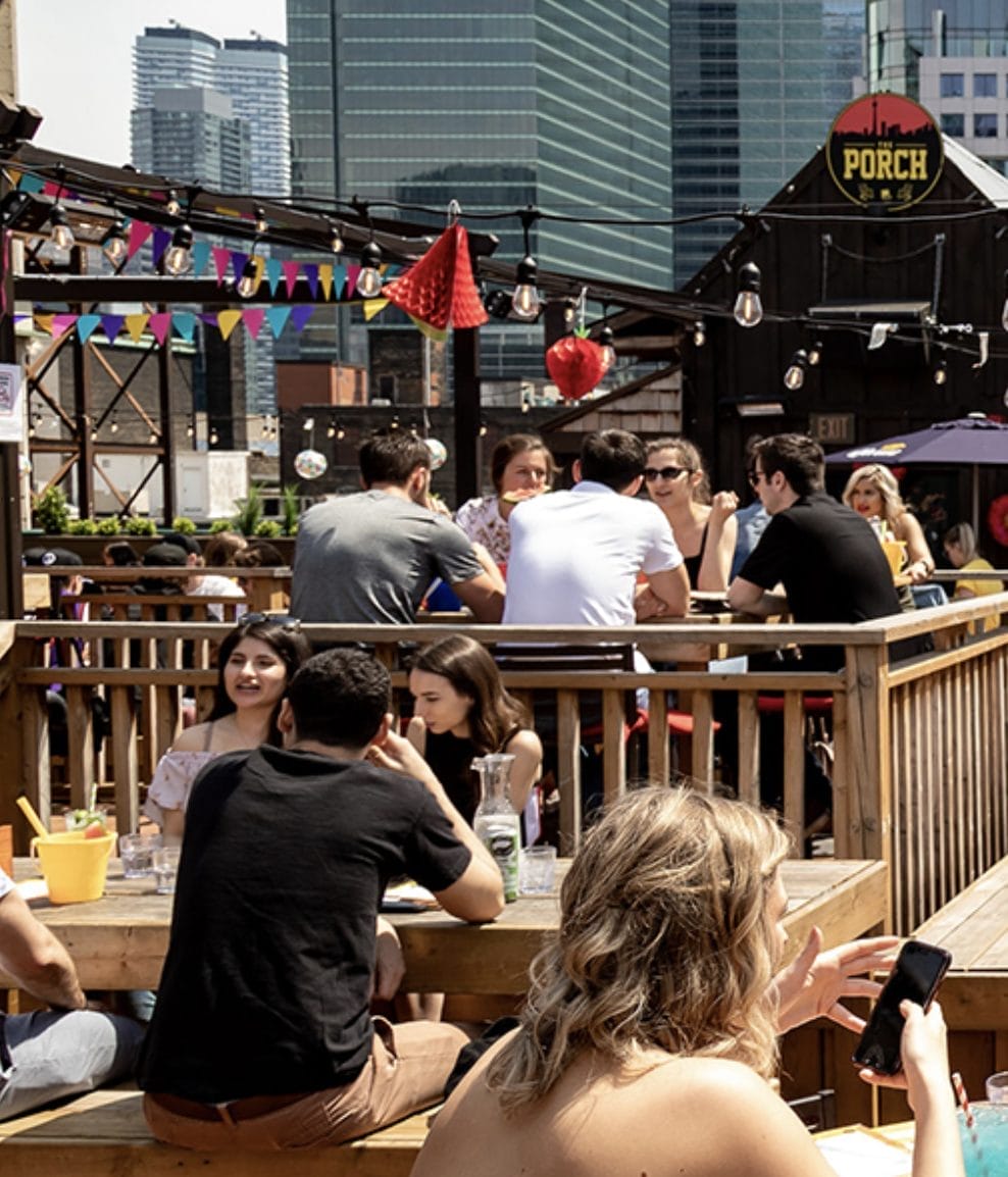 The Porch is a downtown rooftop known for its direct CN Tower views and casual, high-energy patio atmosphere, especially lively on summer evenings.
