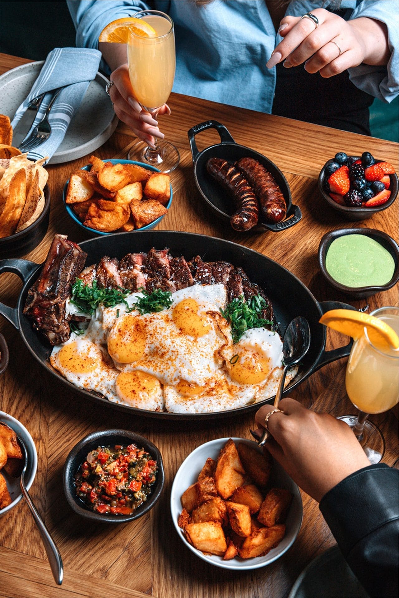 Latin-inspired brunch dish topped with sunny-side-up eggs and fresh greens served at Baro in downtown Toronto.