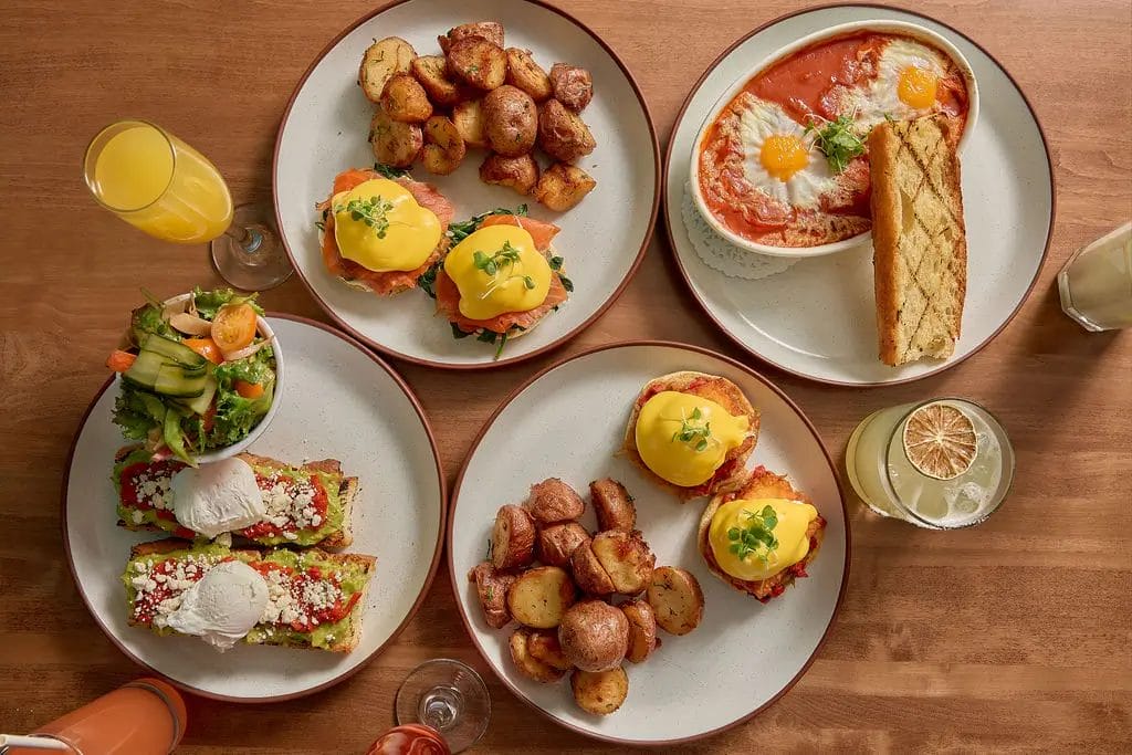Selection of brunch dishes including eggs Benedict, shakshuka, avocado toast, and roasted potatoes served for Father's Day Brunch Toronto at Hot House Restaurant.